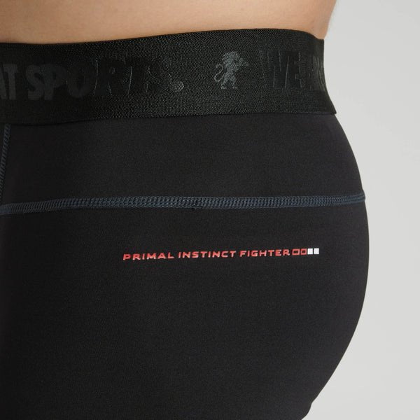 Close-up of the Leone writing printed on the leg of the black leggings