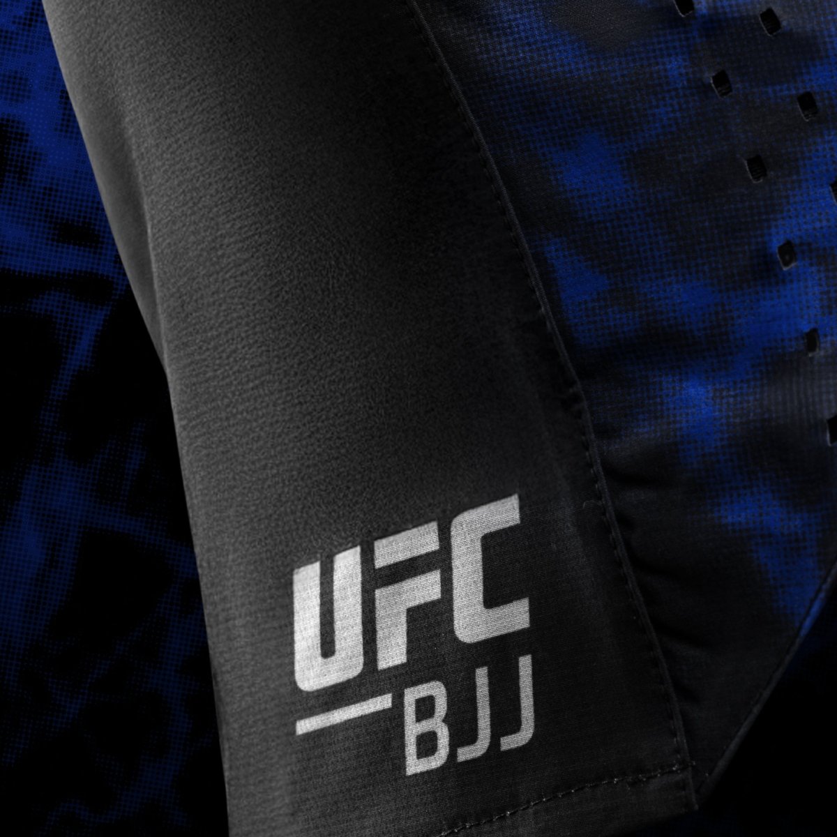 Side detail of the official UFC BJJ logo printed on the black and blue women's shorts