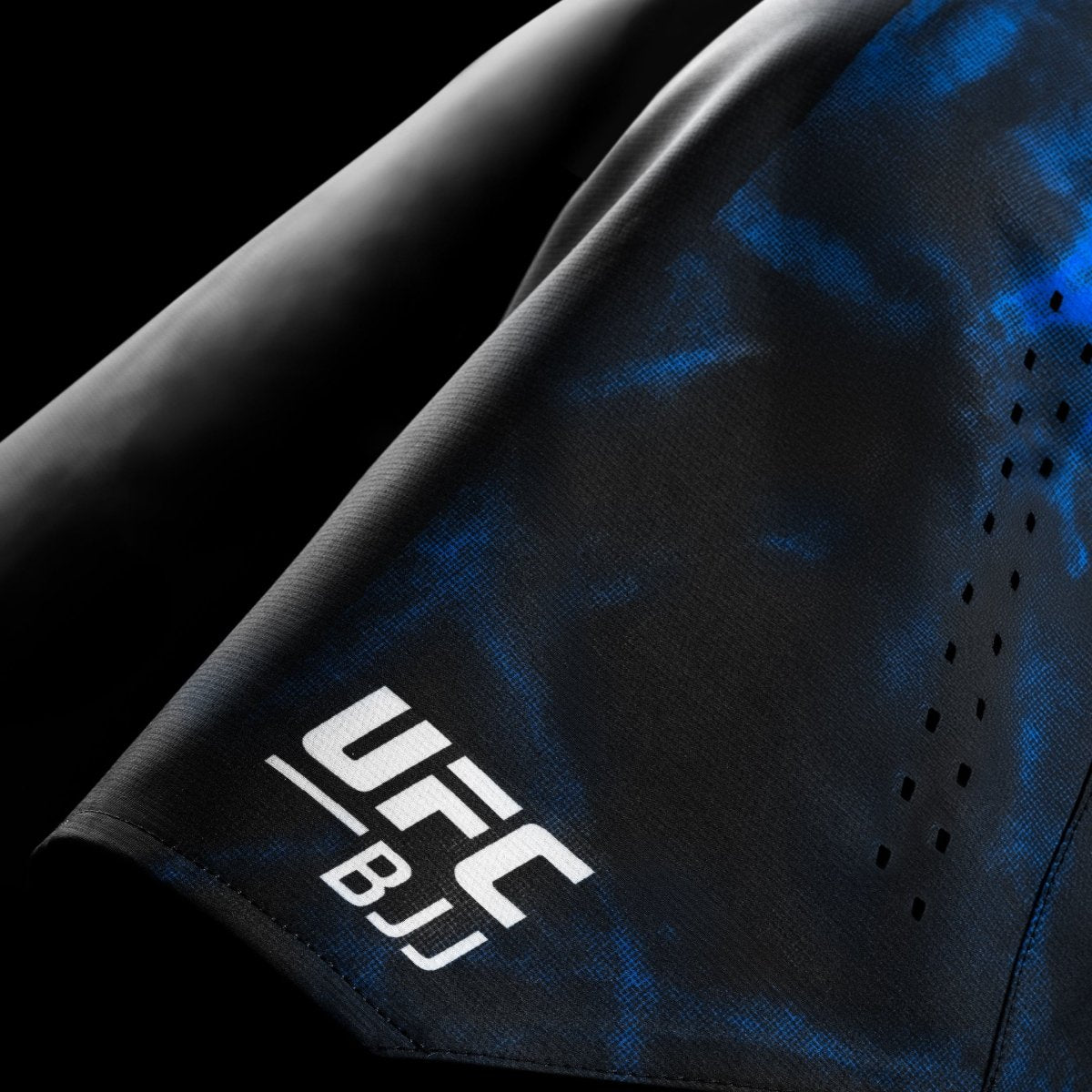 Detail of the UFC BJJ logo and graphics on the black and blue competition shorts