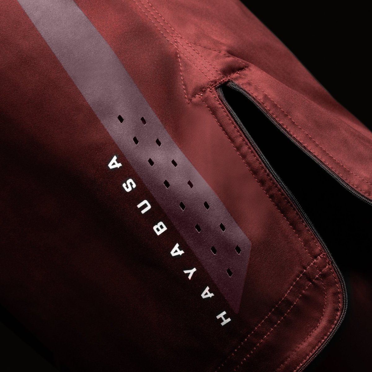 Side view of the red Hayabusa Core Mid-Thigh MMA Shorts, highlights side vents for mobility