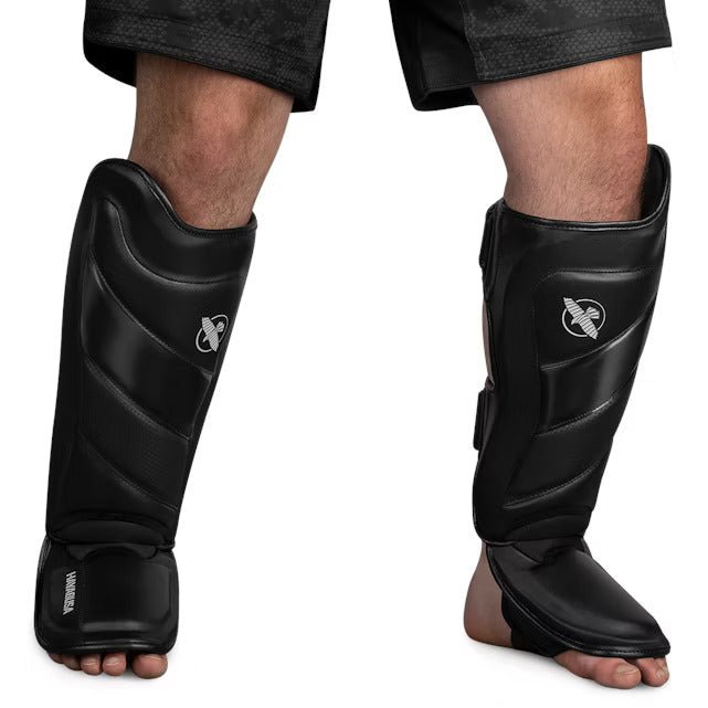 Front view of the black Hayabusa T3 Striking Shin Guard, showing the pre-curved Vylar leather padding