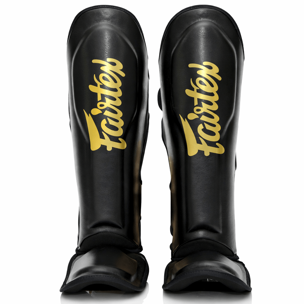 FXB Fairtex benskydd tvåfärgad svart och guldversion med sammärkta logotyper