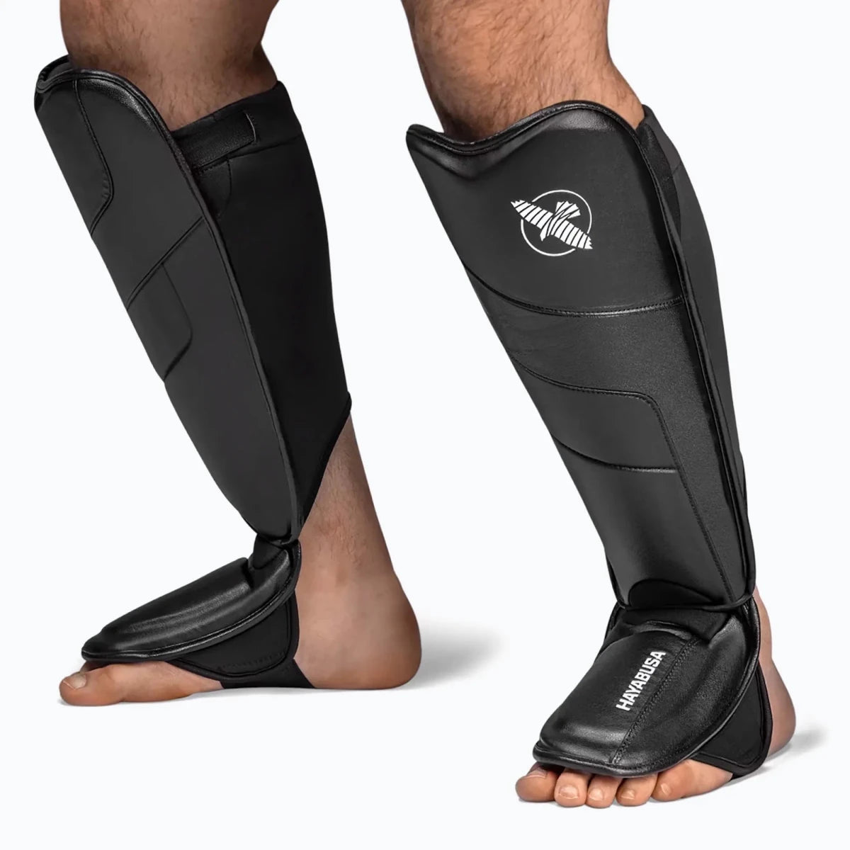 Detail perlindungan multilapis pada tibia pelindung tulang kering T3 berbahan kulit sintetis Vylar hitam.