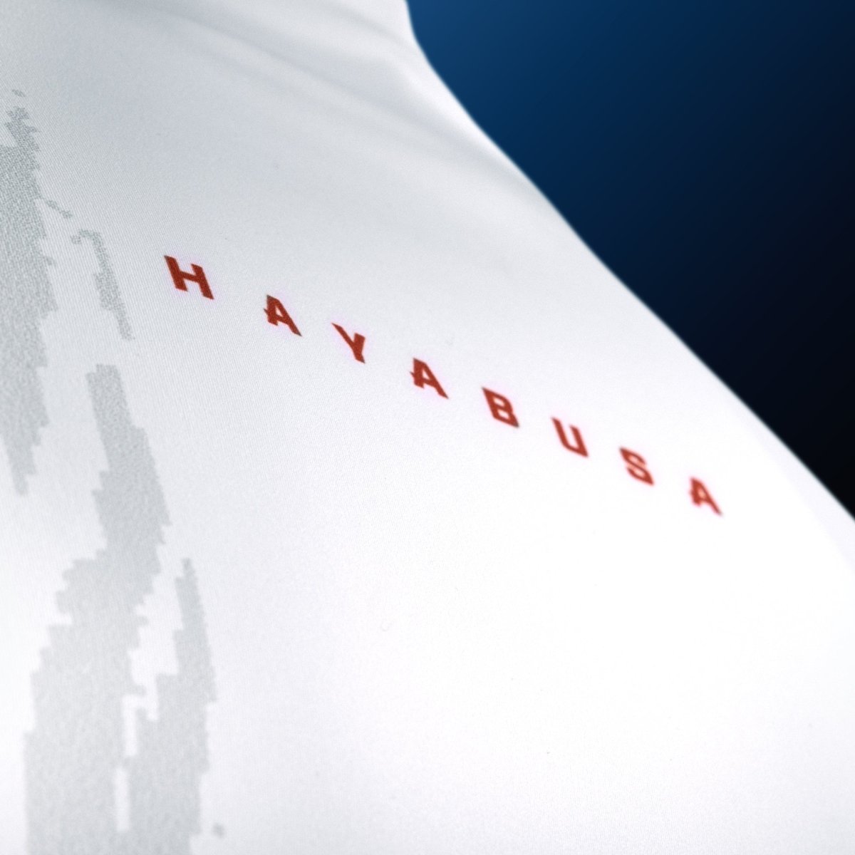 Detail of the high-tensile technical fabric of the white Hayabusa rash guard