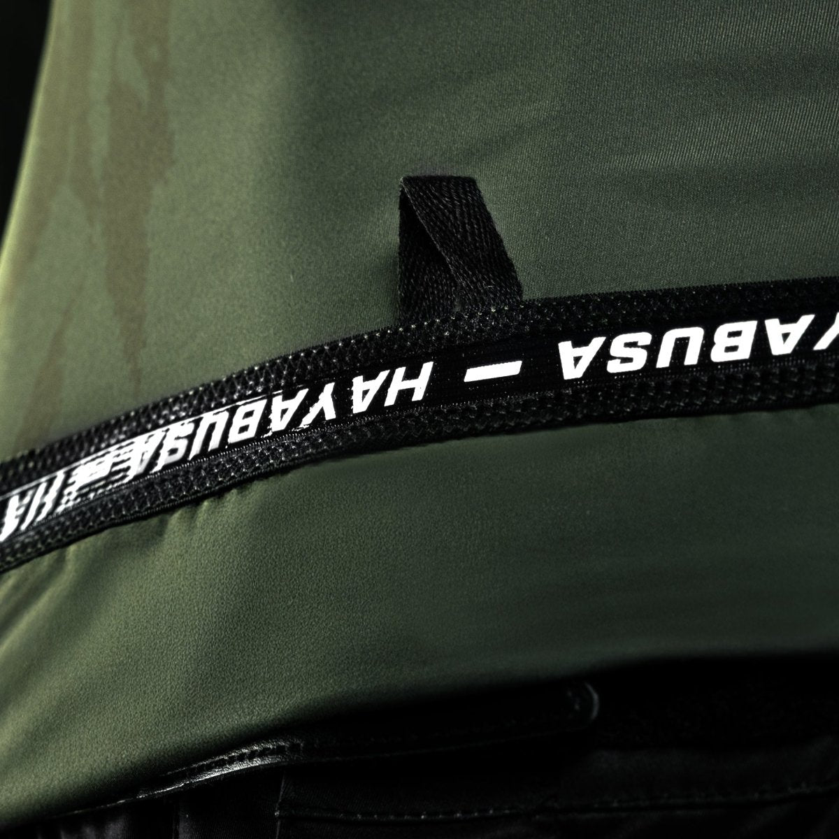 Detail of the frictionless heat-sealed neckline of the green Hayabusa rash guard