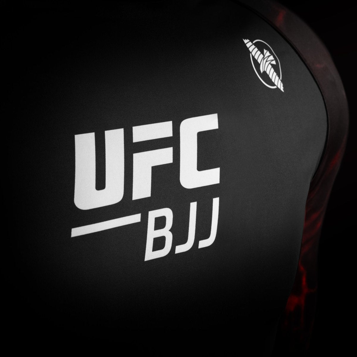 Detail of the official UFC logo on the black and red competition rash guard