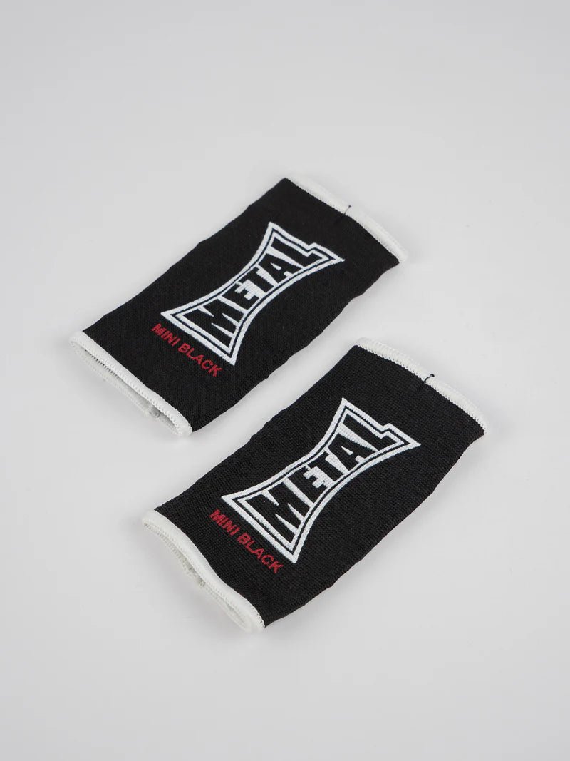 Pair of black Metal Boxing half-finger gloves lying flat, detail of the elastic fabric for children