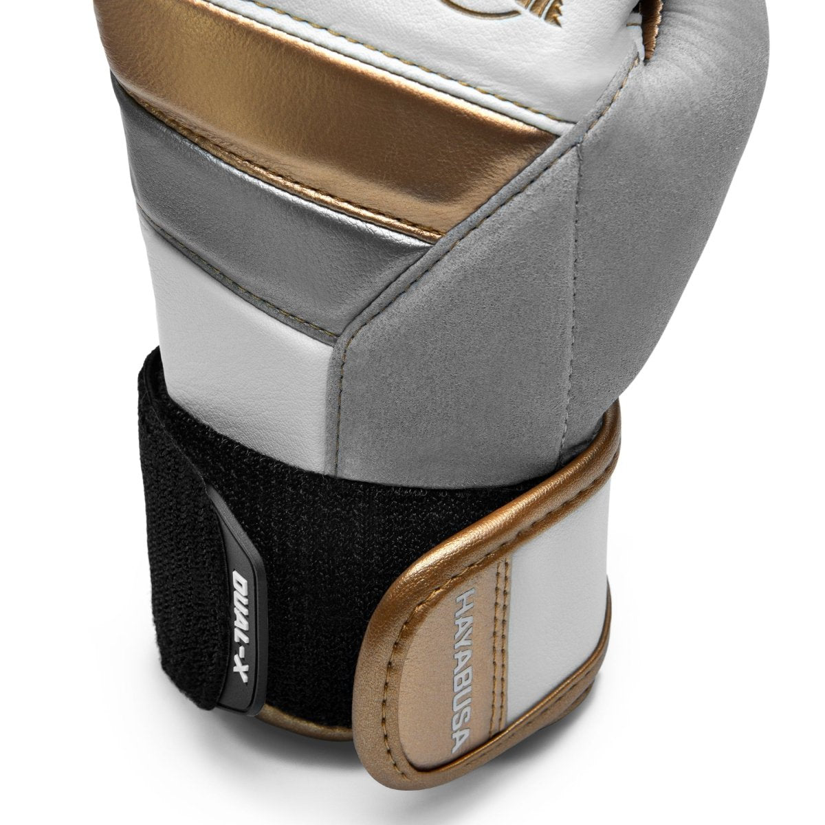 Närbild av den förstärkta stängningen av de vita/guld Hayabusa T3-handskarna