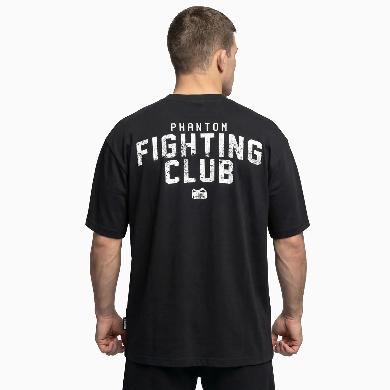 Vista posteriore della t-shirt oversize nera Phantom con la grande scritta grafica Fighting Club sul retro