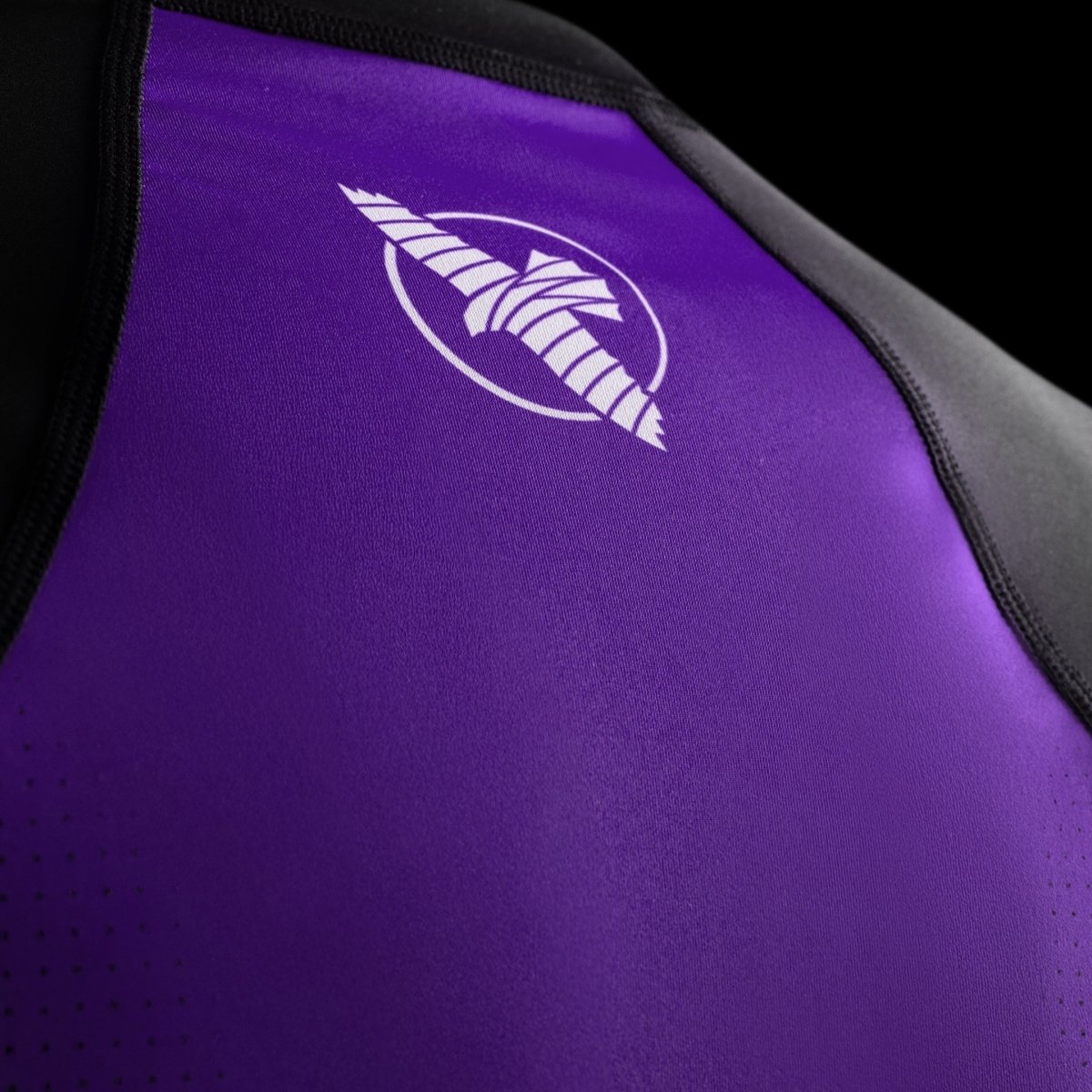 Detail of the Hayabusa branding sublimated on the chest of the purple competition rashguard